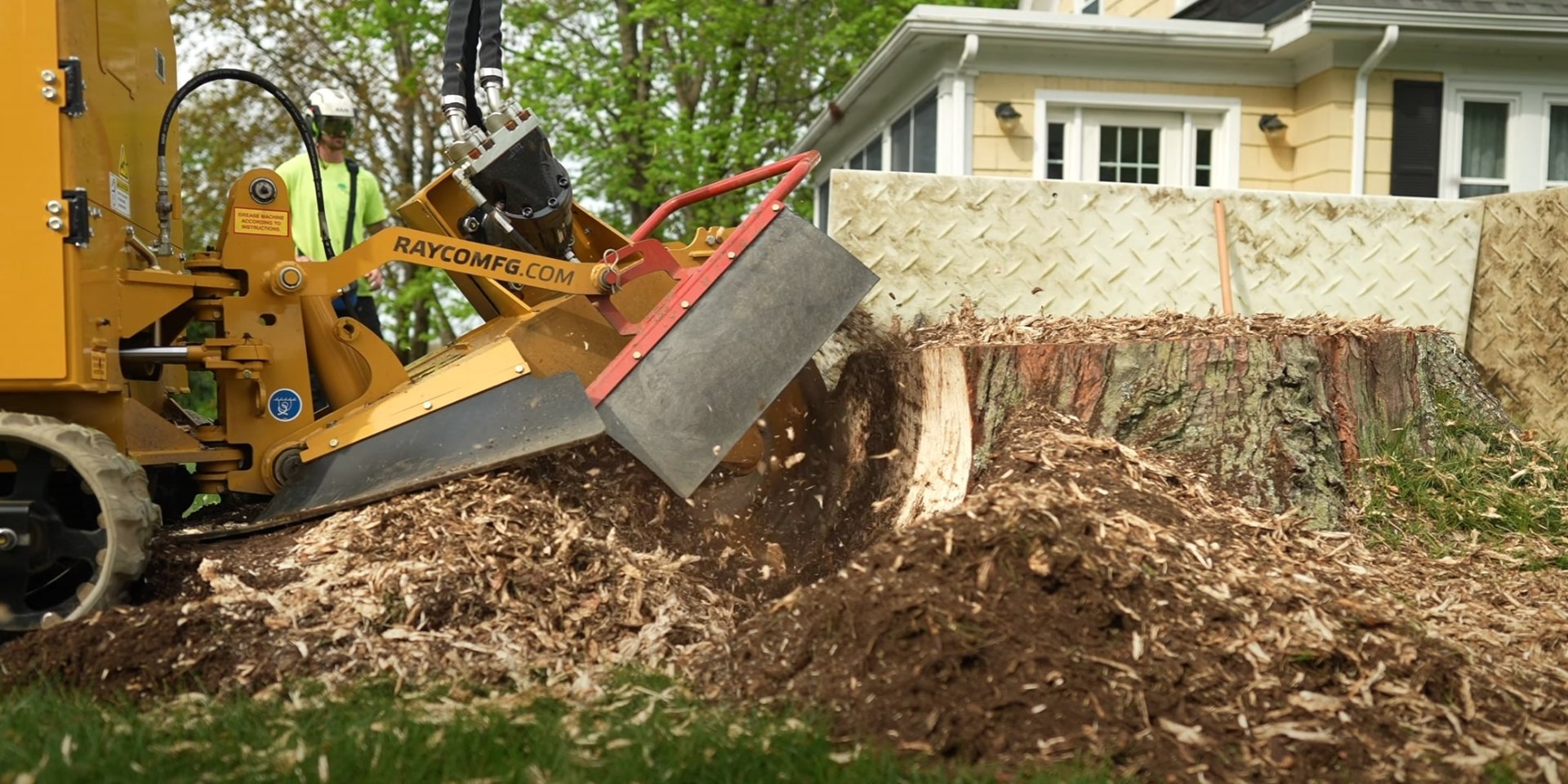 Stump grinding service in Johns Creek Professional stump grinding equipment removing large tree stump with wood chips