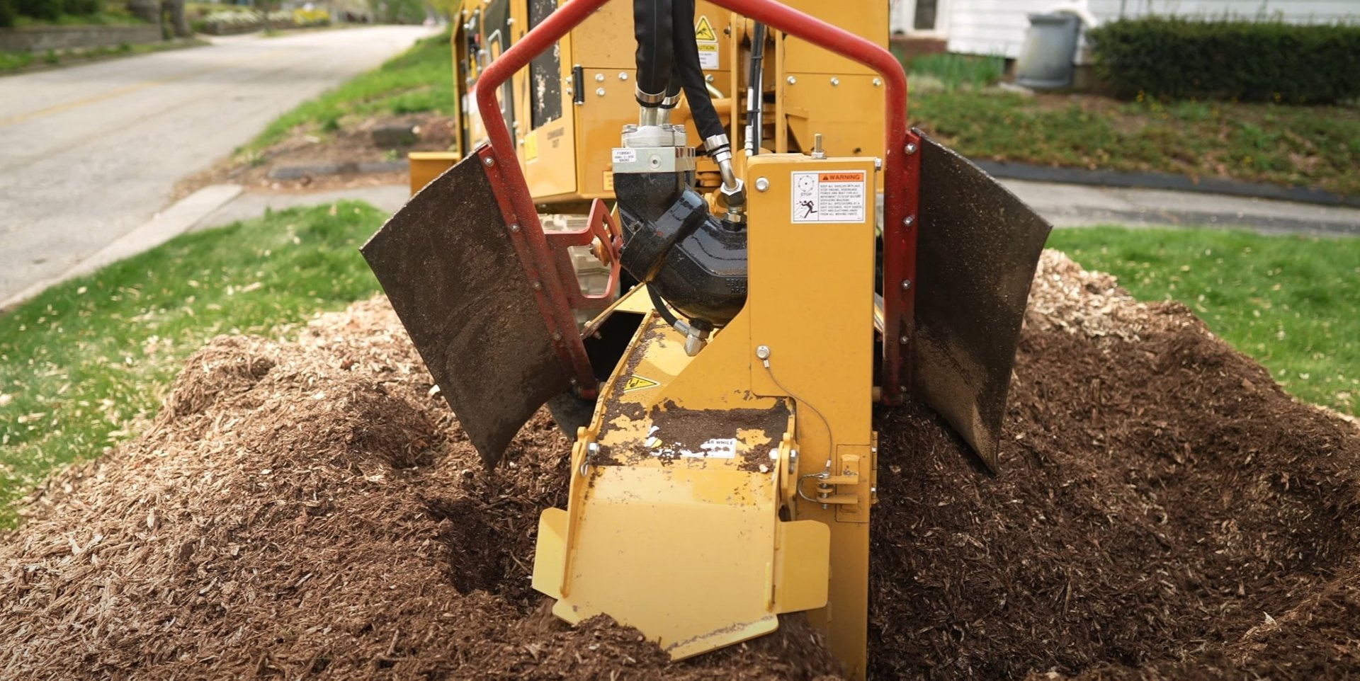 Professional tree service equipment and wood chipper in residential setting